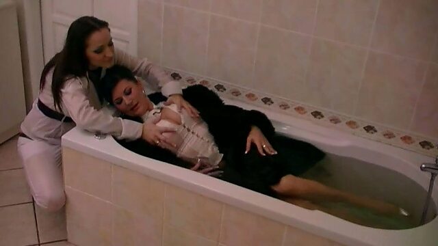 Full clothed couple of MILFs take bath together - water fetish session