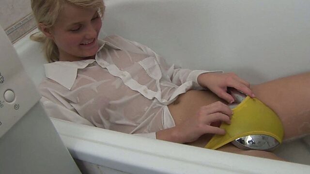 Adorable blond girl Maaike fingers her tight pussy in the bathroom