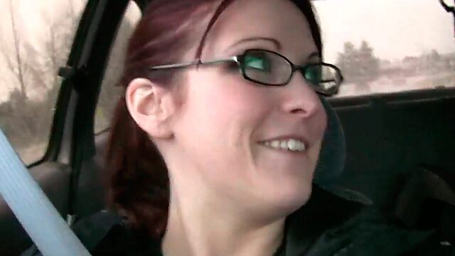 Four eyed red haired girlfriend plays with her pussy in the car