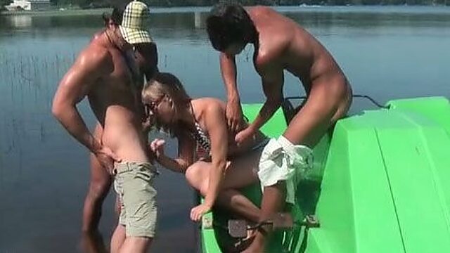 Cute Russian girl is pleasing three horny studs on a boat under the open sky
