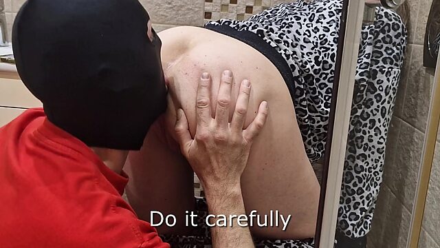 A gimp is using his tongue to clean milf's pussy and asshole