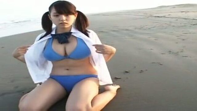 Busty Japanese babe Ai Shinozaki is chilling on a beach wearing seductive bikini